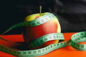 Measurement tape around apple