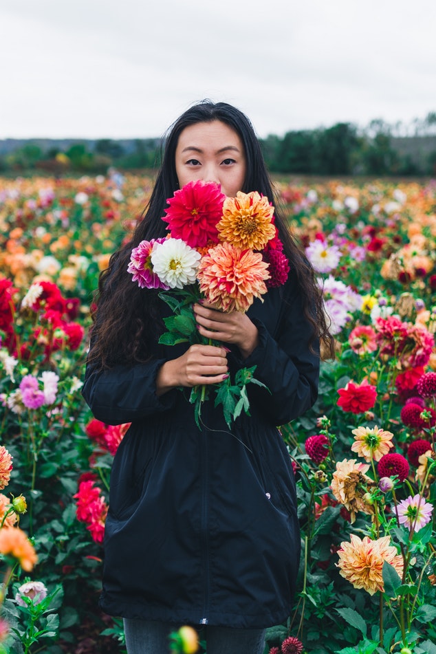 woman holding flowers in a field