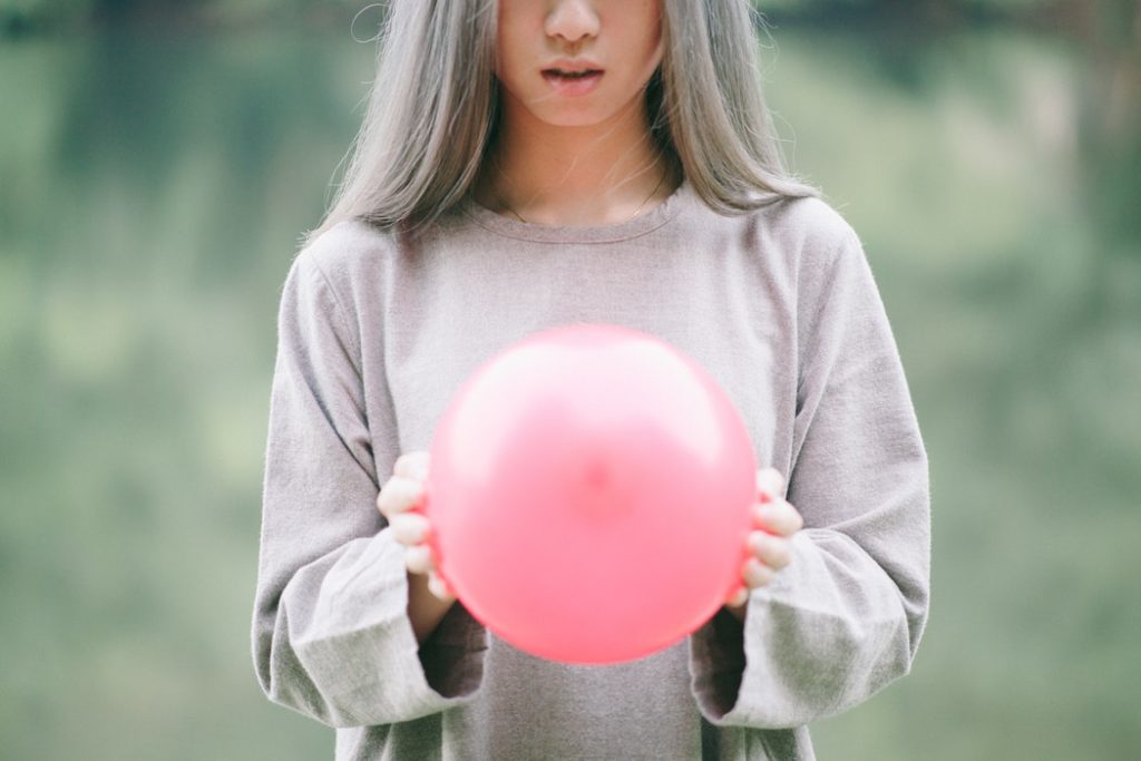 woman holding balloon