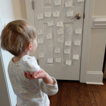 child throwing ball of socks at door