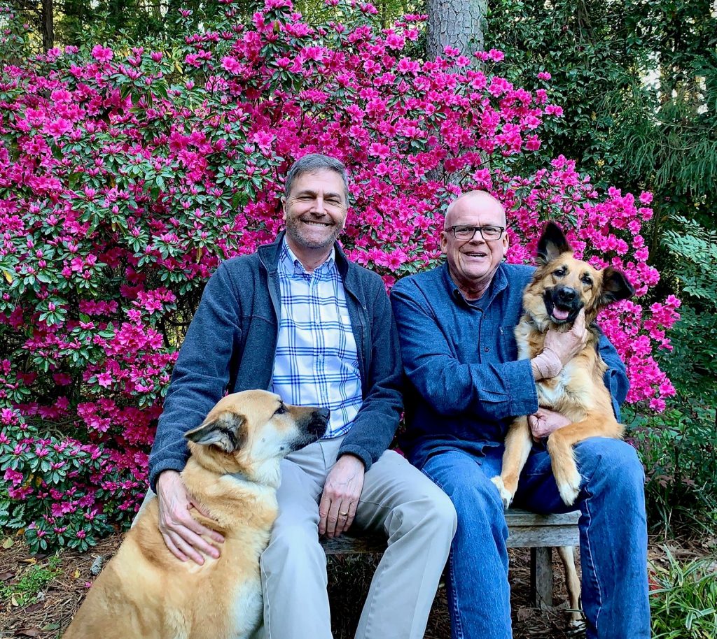 Brian McCann and Tom Costales with their dogs Muuki and Harper Lee. Courtesy of Brian McCann