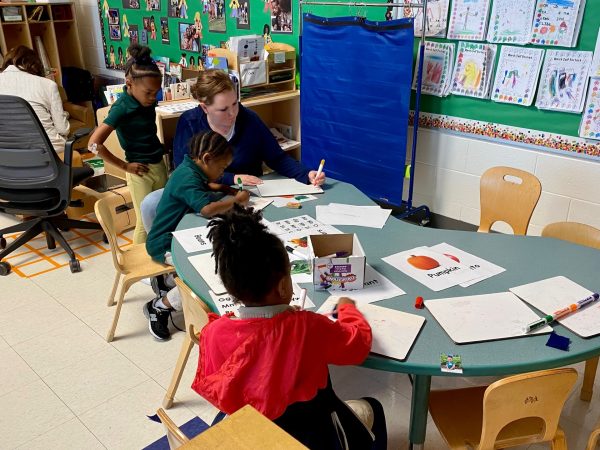 A teacher works with pre-K students at Charles Drew Charter Academy.