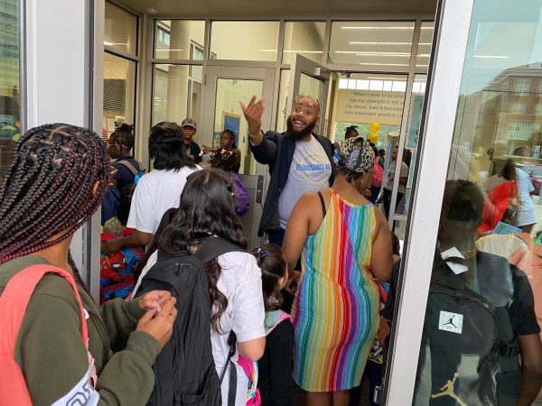 Principal Dwight Thompson welcomes students and families to Renaissance West STEAM Academy on the first day of school Monday.